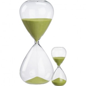 an hourglass with green sand